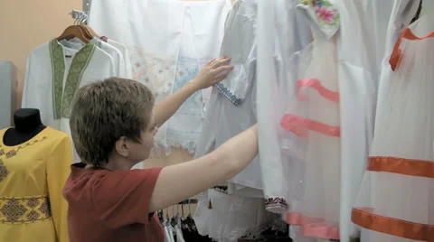 A customer searches for the correct cloth size Stock Footage 65219280