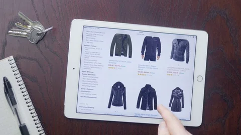 Customer searching for clothes on Amazon website on his iPad Stock Footage 75460521
