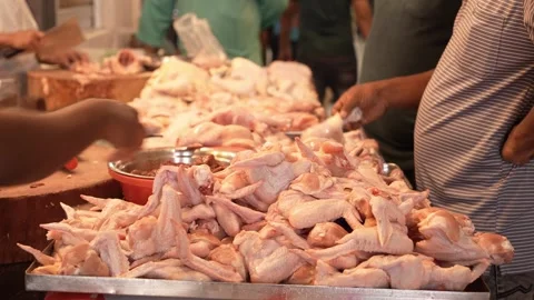 Customer selecting chicken meat at wet market stall Stock Footage 247637725