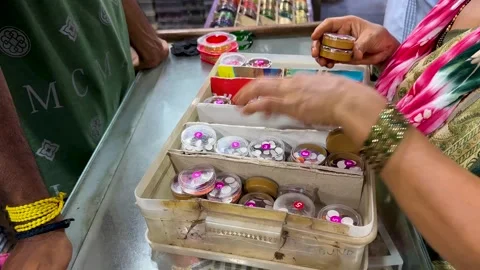 Customer Selecting Colorful Bindi Stickers at Indian Store 4K Stock Footage 336942700