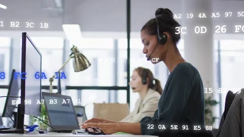 Customer service agent taking call and updating ticket while code overlay Stock Footage 333657494