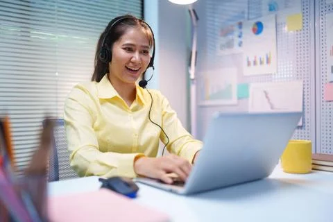 Customer Service Agent Using Headset and Laptop for Online Business Support Stock Photos