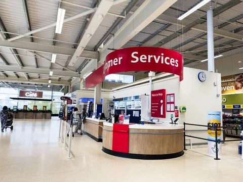 Customer service desk at a Manchester store, busy shopping area, help counter 스톡 사진