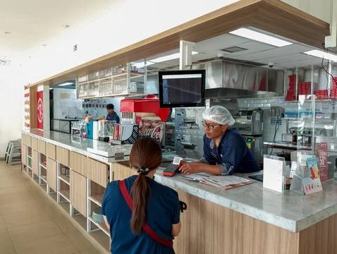 Customer Service Interaction at a Modern Fast Food Restaurant Counter Stock Photos