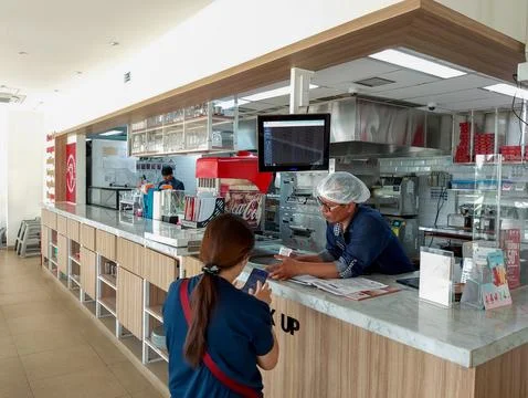 Customer Service Interaction at a Modern Fast Food Restaurant Counter Stock Photos