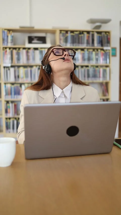 Customer service manager listens to a client while working on laptop Video stock 342179053