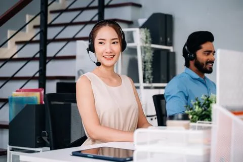Customer service operator with headsets working at call centre Stock Photos