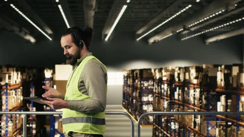 Customer service operator uses headset for phone calls related to package status Stock Footage 330140708