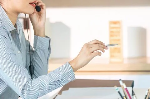 Customer Service Professional Taking Notes During Call Stock Photos