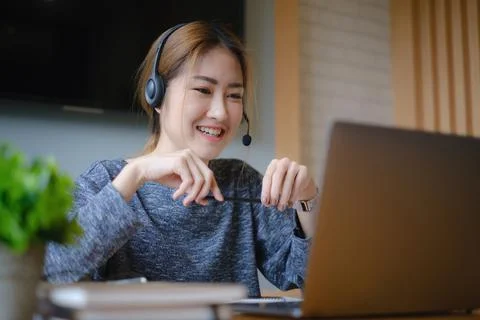 Customer service representative with a headset and work at home. business Stock-Fotos