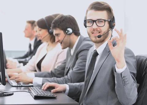 Customer service representative with headset showing sign "OK" Stock Photos