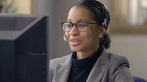 Customer service representative wearing headset talking to client Stock Footage 77327231