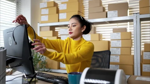 Customer service representative wearing headset working at computer Video stock 326275720