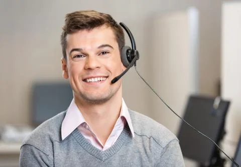 Customer Service Representative Wearing Headset While Smiling In Stock Photos