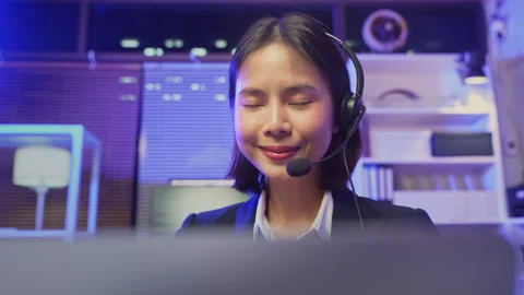 Customer service representative wearing microphone headset and working 스톡 동영상 336491185