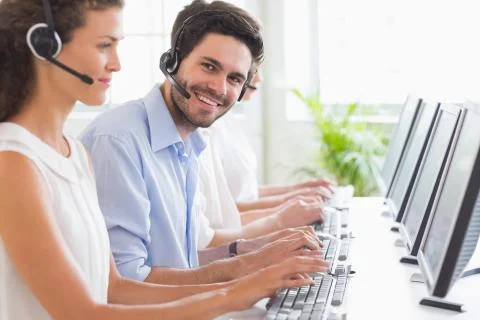 Customer service representative working with colleagues Stock Photos