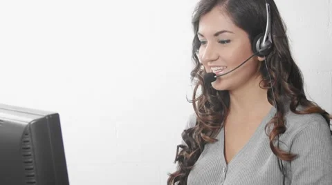 Customer service worker helping out on computer and headset Stock Footage 8521634