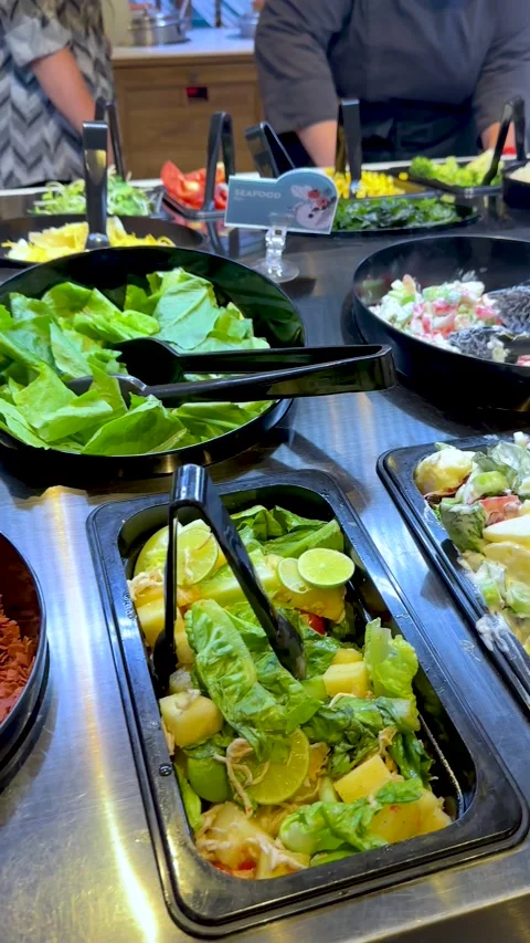 Customer Serving Fresh Salad at Self-Service Buffet Bar Stock Footage 323159587