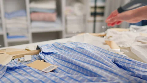 A customer in a shopping store scans the tag label of a new clothing item wi Stock Footage 234721914