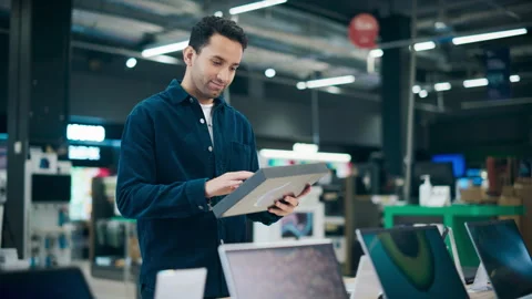 Customer Shopping for Tablet Computer in Electronics Store Stock Footage 243831281