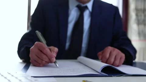 Customer signs contract document with pen Stock Footage 240154509