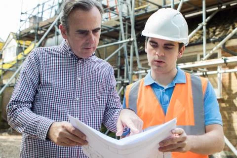 Customer On Site Discussing Plans With Builder Stock Photos