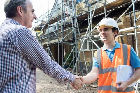 Customer On Site Shaking Hands With Builder Stock Photos