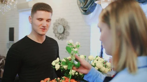 Customer is smelling a flower in a shop to make choice Stock Footage 104010705