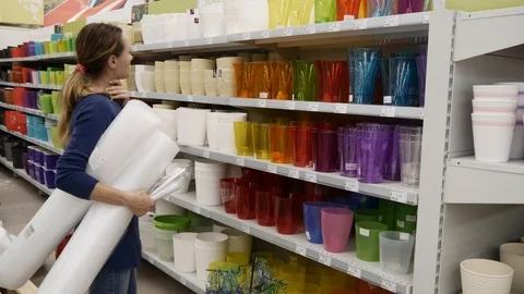The customer stands in front of the shelf in the store Video stock 91064259