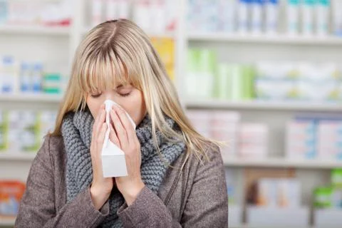 Customer suffering from cold in pharmacy Stock Photos