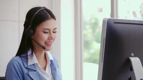 Customer support agent or call center with headset talking to customer on phone. Stock Footage