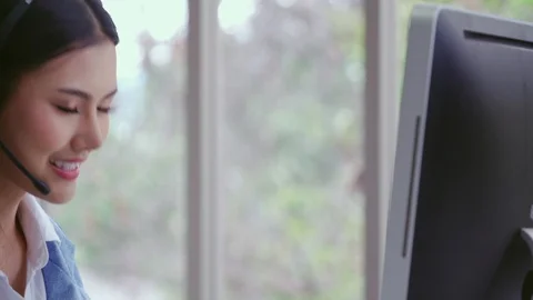 Customer support agent or call center with headset talking to customer on phone. Video stock 119895970