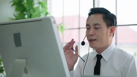 Customer support agent or call center with headset works on desktop computer Stock Footage 155702264