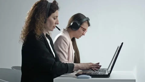 Customer support agent or call center with headset works on desktop computer Stock Footage 156235477