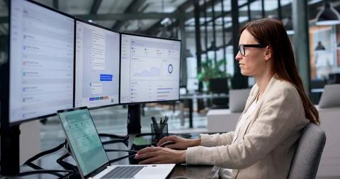 Customer Support Agent Typing Responses Using AI Chatbot Platform At Office. Stock Photos
