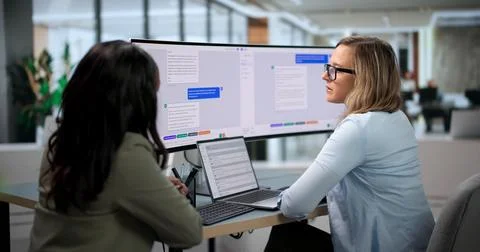 Customer Support Agents Collaborate Using AI Chatbot Software On Laptop Scree Stock Photos
