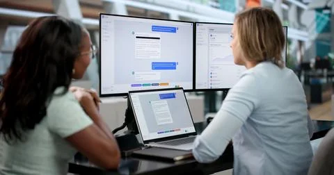 Customer Support Agents Collaborate Using AI Chatbot Platform On Laptops Toge Stock Photos