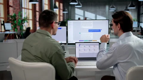 Customer Support Agents Discuss Improving AI Chatbot Platform Stock Footage 347903180