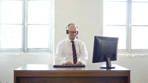 Customer support concept: handsome worker sitting on office desk, taking his Stock Footage 143296834