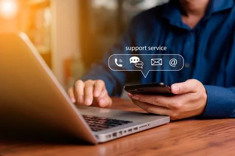 Customer support concept. Man using smartphone and laptop with virtual chat.. Stock Photos