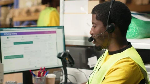 Customer support employee assisting clients in an industrial logistics hub Stock Footage 315540468