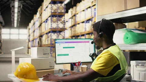 Customer support employee assisting clients in an industrial logistics hub Stock Footage 315541074