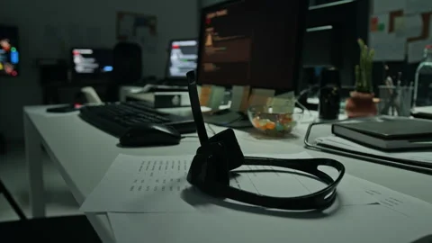 Customer Support Headset Resting on Desk in Empty Office at Night Stock Footage 346698640