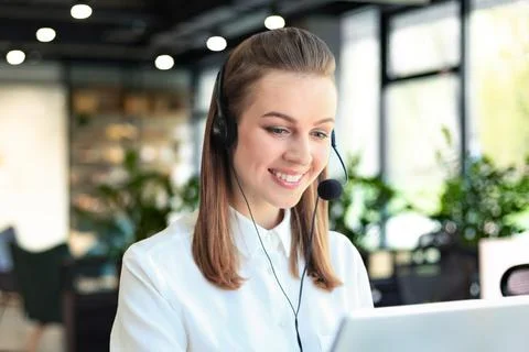 Customer support operator working in a call center office Stock Photos