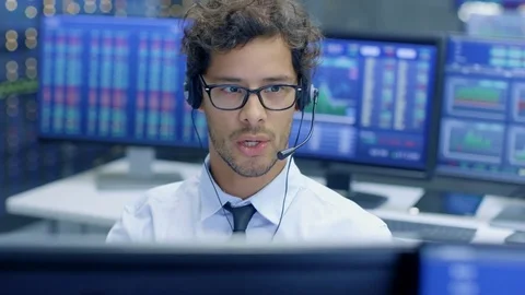 Customer Support Service Representative Talks with a Client Through Headset.  Stock Footage 81277403