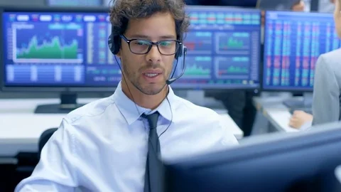 Customer Support Service Representative Talks with a Client Through Headset.  Stock Footage 81277649