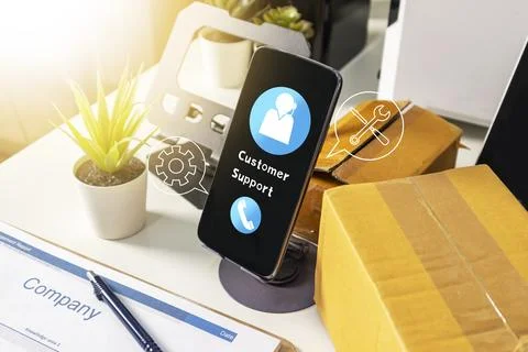 Customer support service on smartphone screen with delivery boxes and offic.. Stock Photos