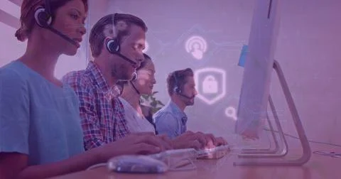 Customer support team using headsets and computers in modern office environment 스톡 사진
