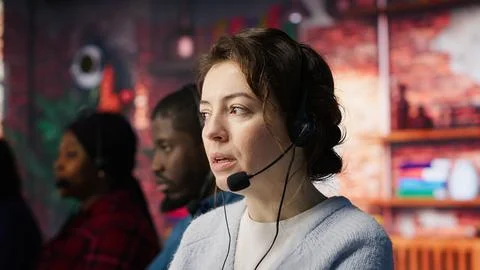 Customer support workers assist customers with technical issues Stock Photos