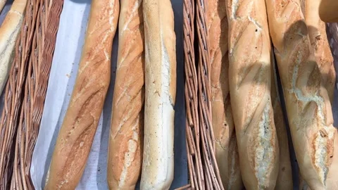 A customer takes a loaf of bread from the counter Stock Footage 311649180